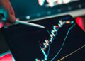 XRP coin on a digital trading screen with fluctuating market charts and liquidation alerts.