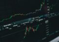 A downward graph line with Bitcoin symbols illustrating a decline in cryptocurrency value.