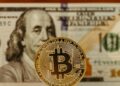 A gavel rests on a table beside a cryptocurrency coin, symbolizing legal action in finance.