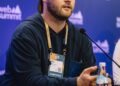 TRON DAO team presents AI and stablecoin innovations at a tech conference stage.