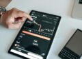 A digital blockchain graphic overlaid with financial charts and regulatory text.