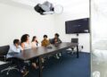 A professional team discusses blockchain technology in a modern office setting.