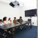 A professional team discusses blockchain technology in a modern office setting.