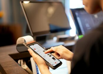 A smartphone displaying a Bitcoin payment screen in a retail setting.