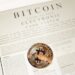 Vancouver City Hall with a Bitcoin symbol and legal documents in the foreground.