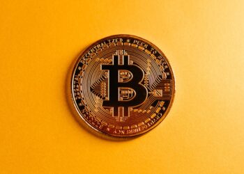 A digital graphic depicting a blockchain network with cryptocurrencies and financial symbols.