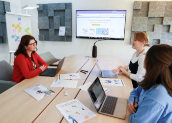 Two executives discussing strategies in a modern office, symbolizing innovation in prediction markets.