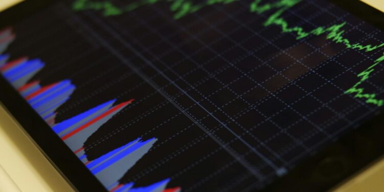 HYPE Tokens displayed on a digital screen with graphs showing crypto market fluctuations.
