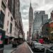 Modern office building in NYC with Ledger branding and a bustling urban backdrop.
