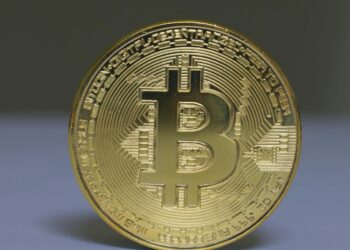 A digital rendering of a blockchain network with currency symbols and AI elements.