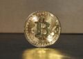 Investor hands holding a digital token symbolizing financial growth and investment in cryptocurrency.
