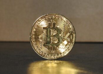 Investor hands holding a digital token symbolizing financial growth and investment in cryptocurrency.