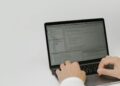 A developer using OpenAI's new Superapp interface on a laptop, showcasing its features.