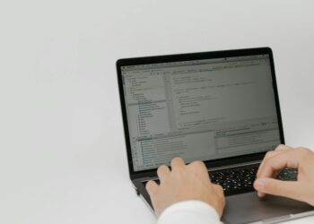 A developer using OpenAI's new Superapp interface on a laptop, showcasing its features.