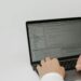 A developer using OpenAI's new Superapp interface on a laptop, showcasing its features.