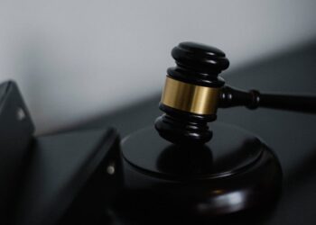 Gavel and legal documents on a table, symbolizing gambling regulation and legal action.