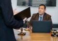 A courtroom scene with lawyers discussing cryptocurrency legal issues.