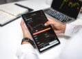 A financial advisor reviews cryptocurrency regulations on a digital tablet.