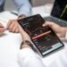 Two professionals discussing cryptocurrencies with charts and data on screens around them.