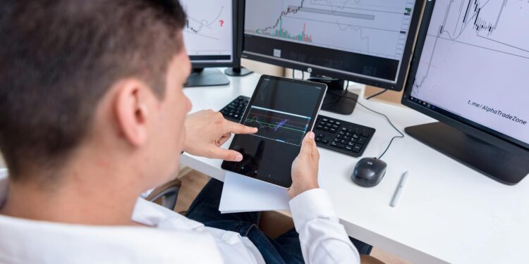 An investor analyzing cryptocurrency trends on a digital tablet.