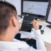 A financial analyst reviewing charts on a digital display related to crypto profits.