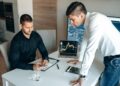 Regulators discuss cryptocurrency regulations at a conference with charts and graphs.