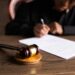 Federal judge deliberating at a legal desk with documents about Pentagon regulations.