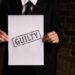 Courtroom scene with a man in a suit admitting guilt related to music royalties fraud.
