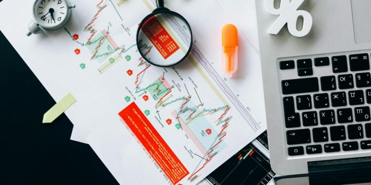 Stock market graphs with cryptocurrency icons and legal documents on a table, symbolizing shareholder dispute.
