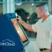 A digital payment terminal showcasing crypto options for tourists in South Korea.