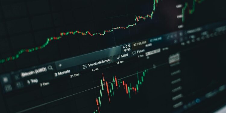 Traders monitoring cryptocurrency prices on screens, highlighting XRP and Solana declines.