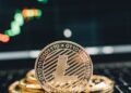 A stack of cryptocurrency coins with financial charts and graphs in the background.