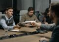 A conference table with documents and digital currency symbols, discussing stablecoin regulation.