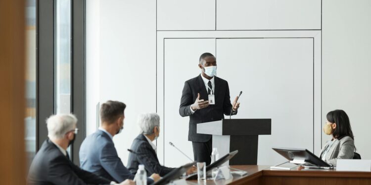 Two professionals discussing cryptocurrency regulations at a conference setting.