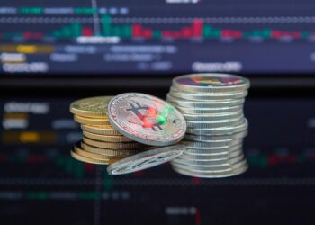 Cryptocurrency-themed graphics with charts and digital tokens representing new tokenized ETFs.