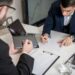 Business meeting with advisors discussing cryptocurrency and AI policy regulations.