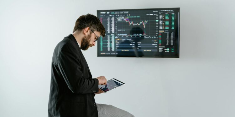 A financial analyst reviewing cryptocurrency trends on a digital tablet.
