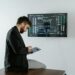 A financial analyst discusses cryptocurrency regulations with XRP graphics displayed on a screen.