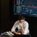Traders monitor Bitcoin prices on screens in a financial office, highlighting ETF market activity.