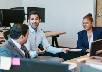 Fidelity employees discussing regulatory compliance for cryptocurrency services.