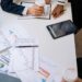 Business people discussing financial strategies with charts and documents.