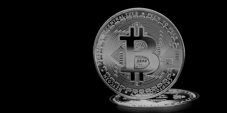 A digital representation of Bitcoin symbols with mining equipment and financial graphs.