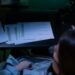 A financial analyst reviewing cryptocurrency audit documents at a desk.