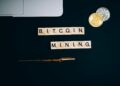 Bitcoin mining rigs illuminated in a dark room, showcasing cryptocurrency operations.