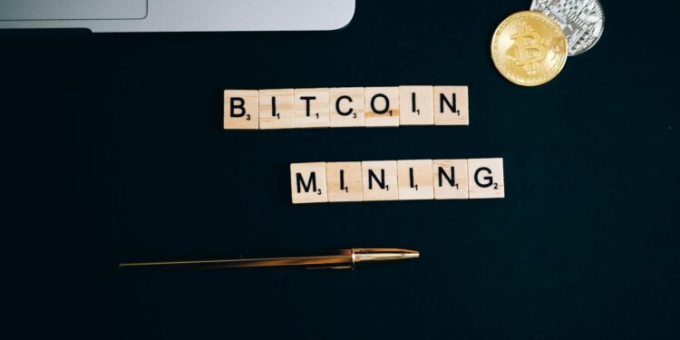 Bitcoin mining rigs illuminated in a dark room, showcasing cryptocurrency operations.