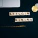 Bitcoin mining rigs illuminated in a dark room, showcasing cryptocurrency operations.