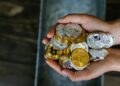 Six individuals linked to cryptocurrency laundering on a digital finance background.