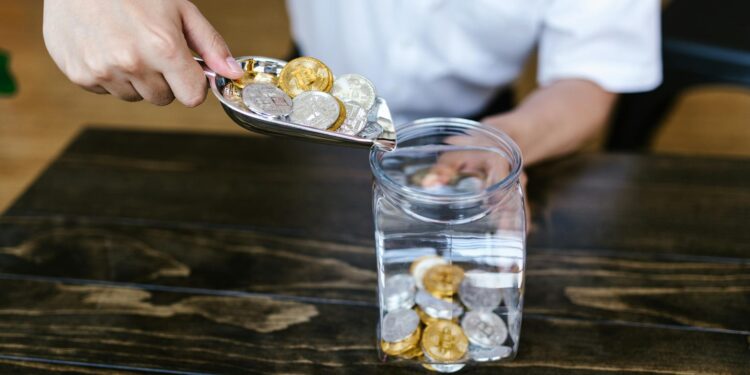 Gold coins and crypto tokens scattered on a table, representing stablecoin thUSD launch.