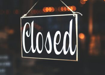 Bitcoin Depot kiosk with warning signs posted about suspended operations in Connecticut.