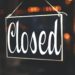 Bitcoin Depot kiosk with warning signs posted about suspended operations in Connecticut.
